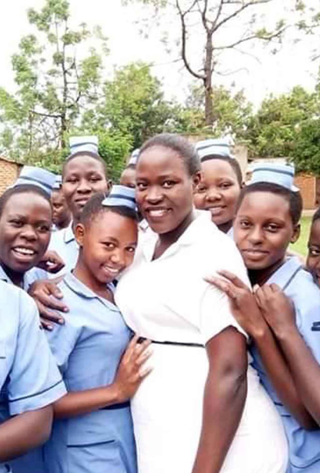 Group of nursing students standing with a nurse in a anume campus